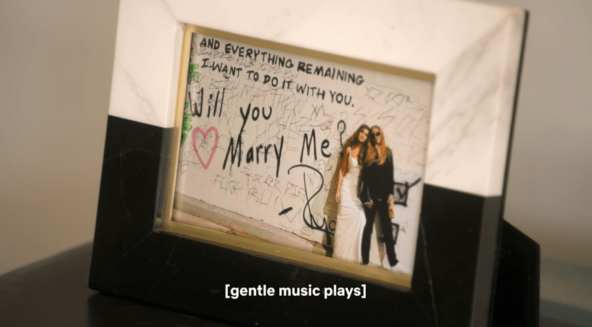 A framed photo of Chrishell Stause and her partner G Flip, with “And everything remaining I want to do it with you. Will you marry me?” handwritten on the photo